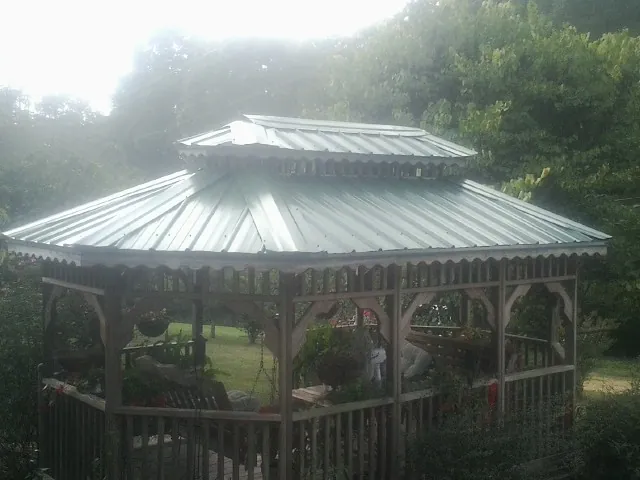 Two tier green metal roof on a garden gazebo in Bradford